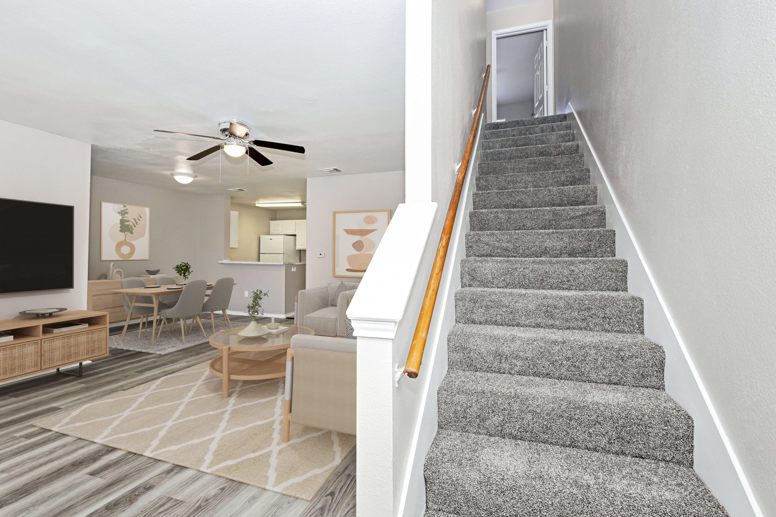 a living room filled with furniture and a stairway