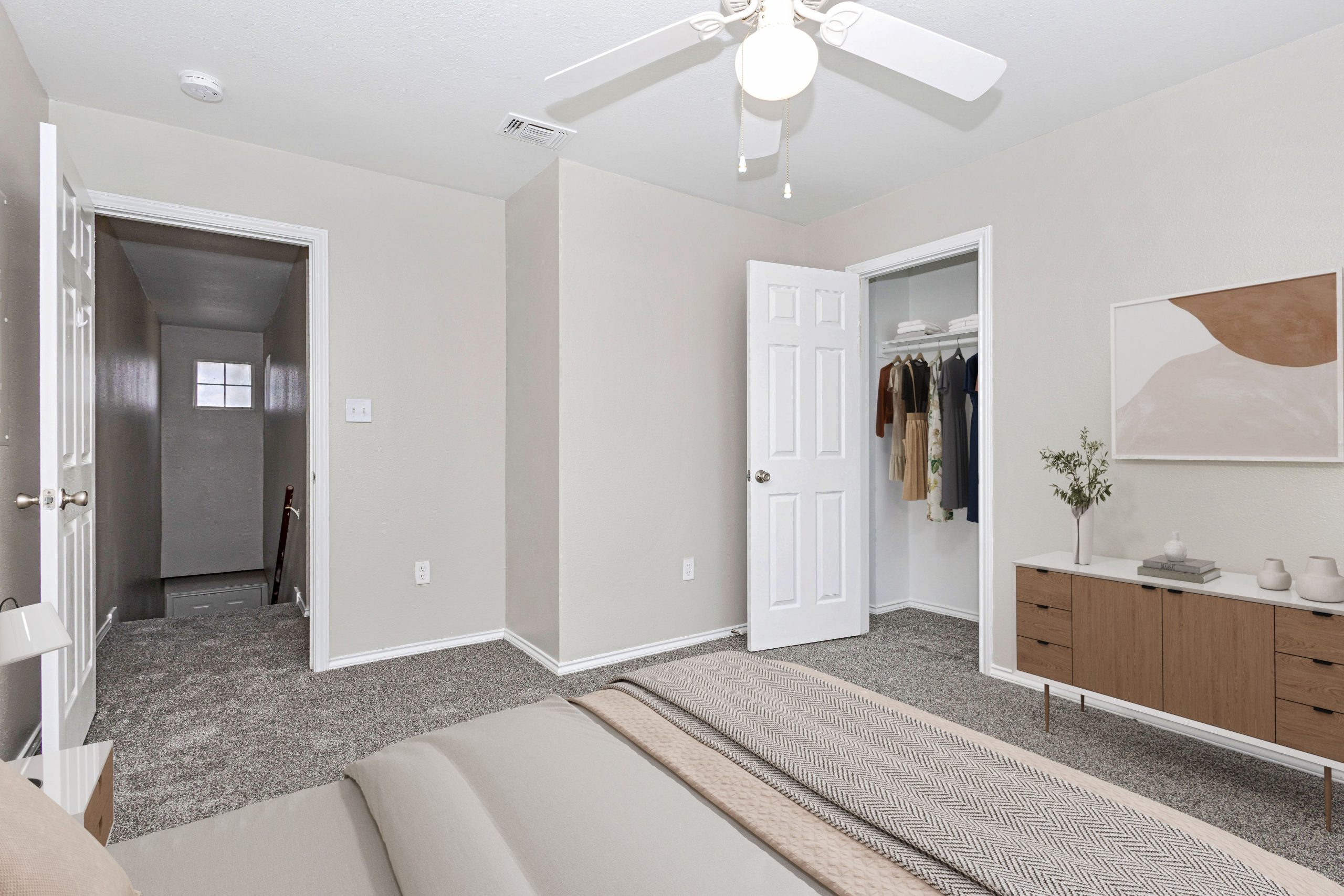 a room with a white wall and a white refrigerator